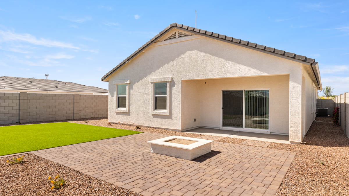 Large fenced-in backyard with a covered patio, perfect for outdoor entertaining.