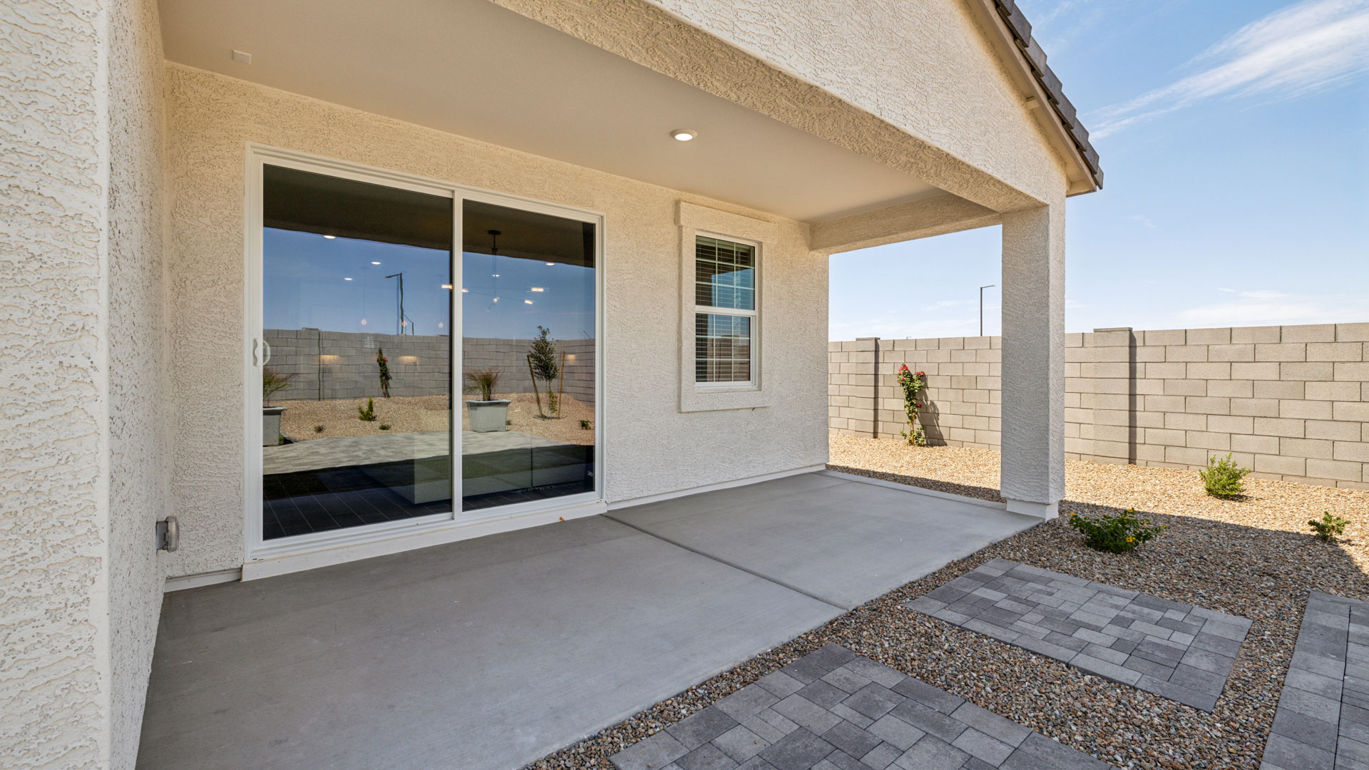 Large fenced-in backyard with a covered patio, perfect for outdoor entertaining.
