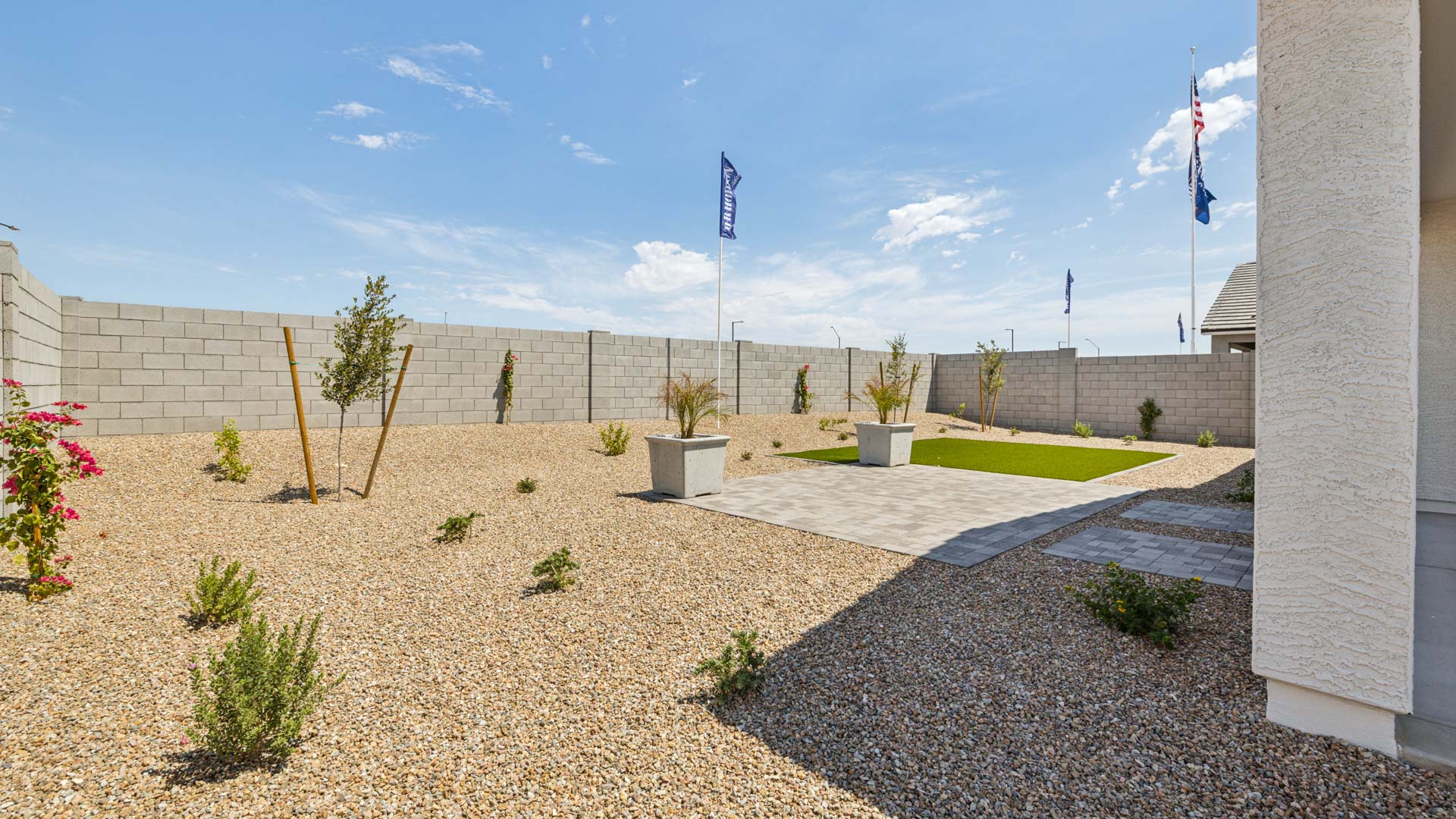 Outdoor covered patio with seating area overlooking a well-maintained lawn, perfect for relaxation.