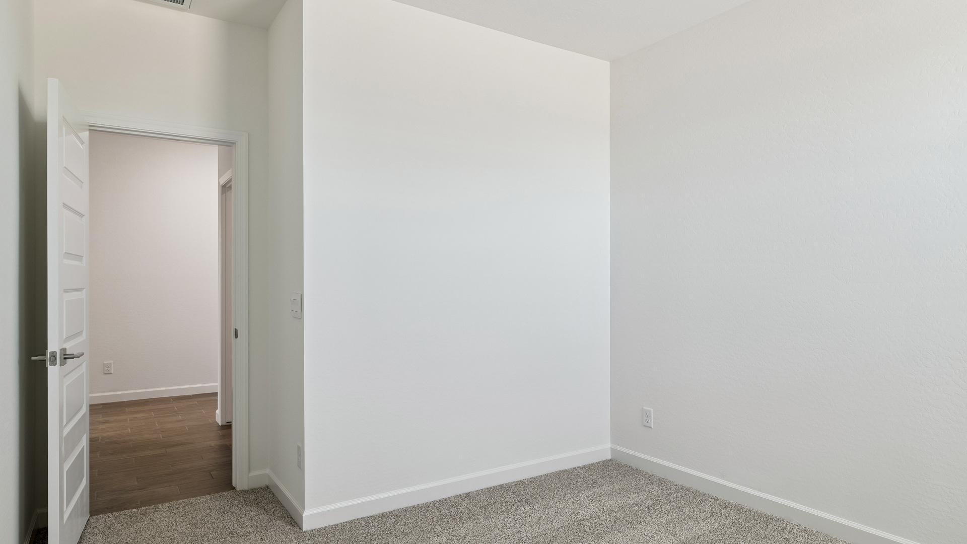 Comfortable guest bedroom featuring neutral-toned walls and a large closet.