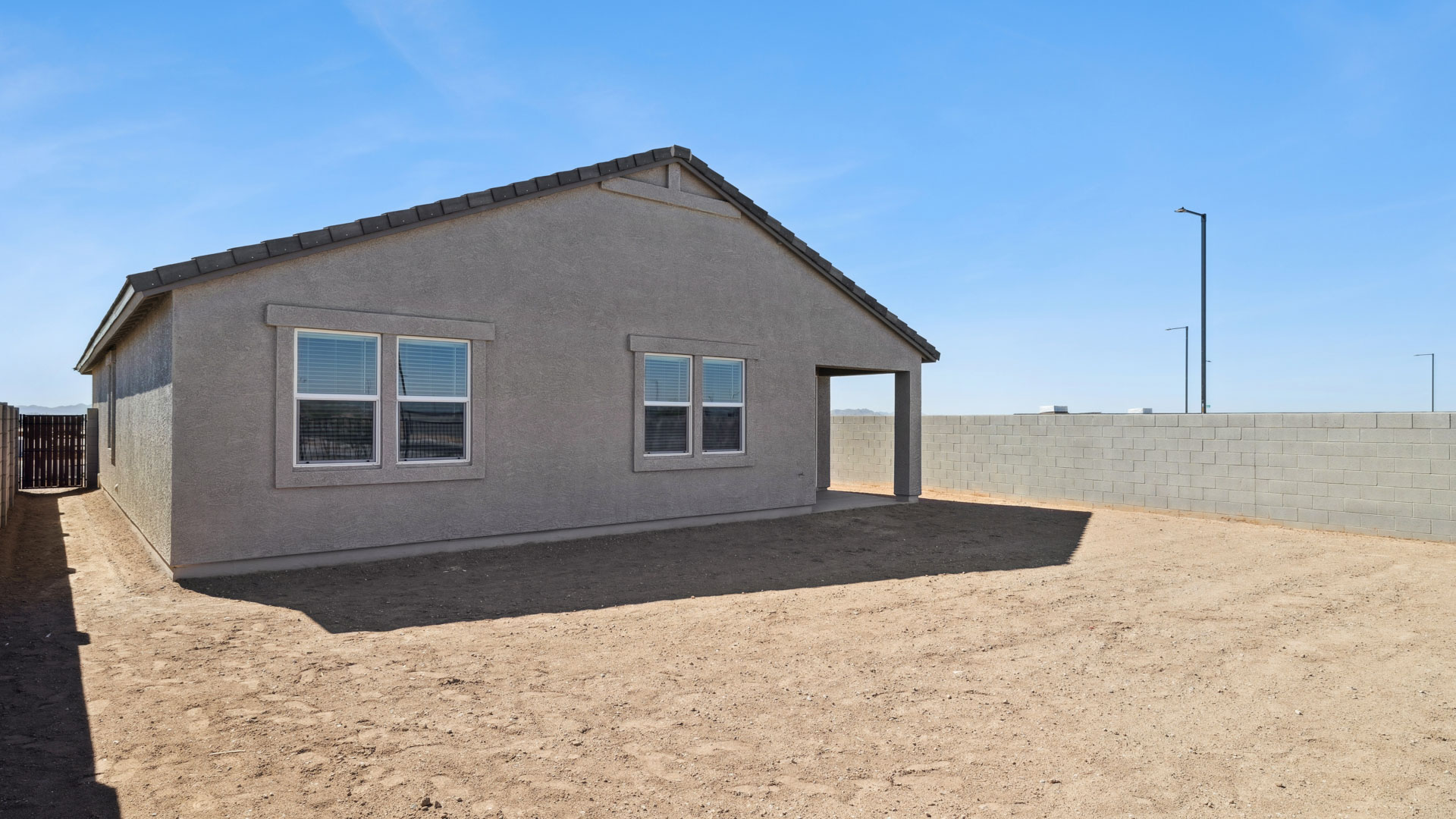 Large fenced-in backyard with a covered patio, perfect for outdoor entertaining.