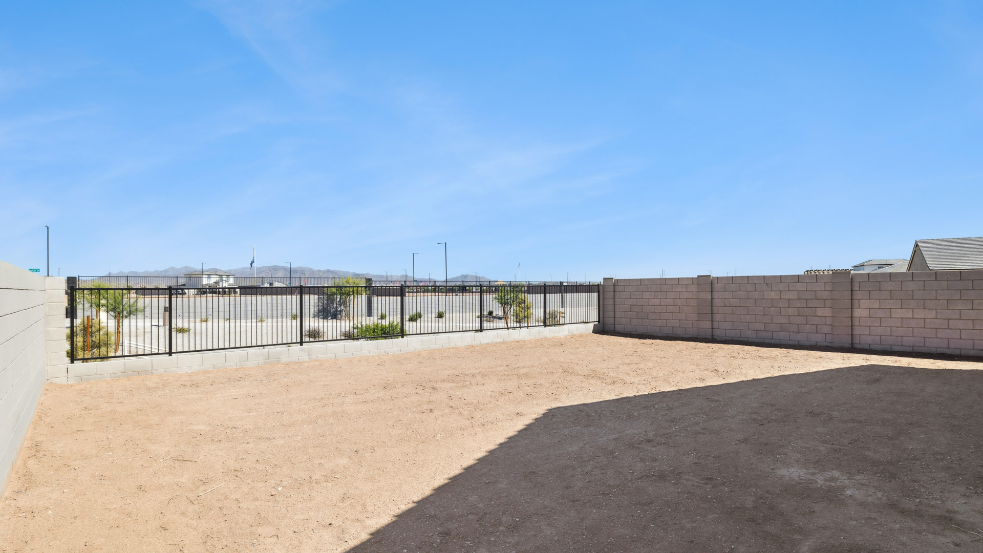 Large fenced-in backyard with a covered patio, perfect for outdoor entertaining.