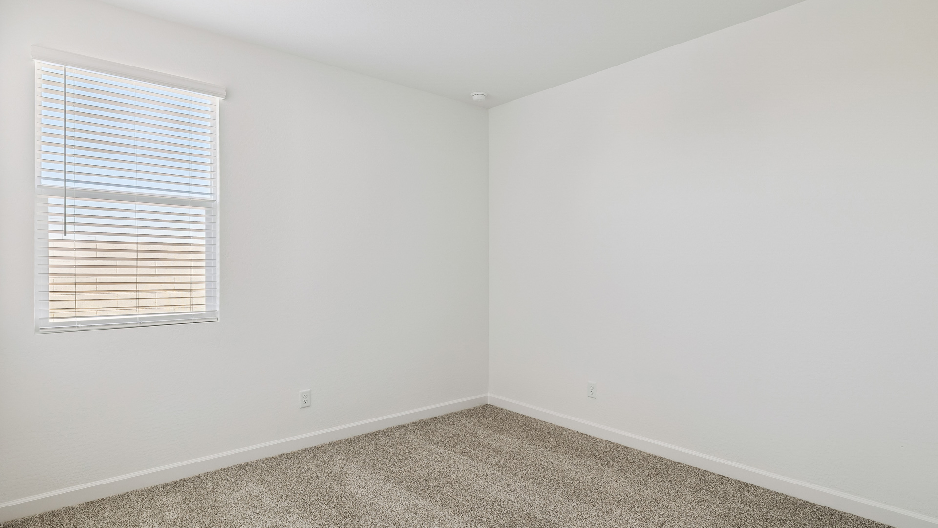 Comfortable guest bedroom featuring neutral-toned walls and a large closet.