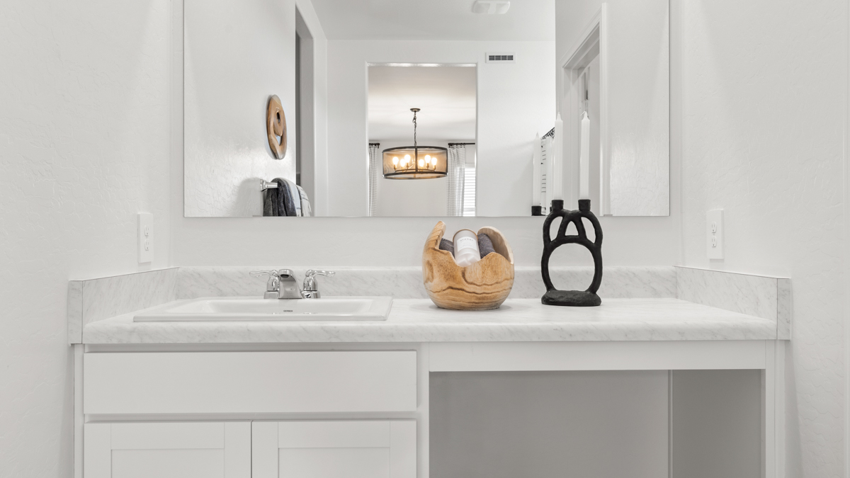 primary bathroom with dual vanities