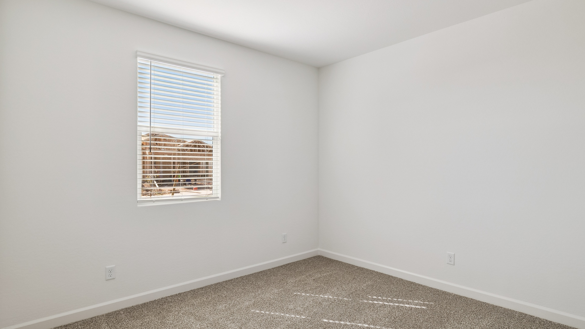 Comfortable guest bedroom featuring neutral-toned walls and a large closet.