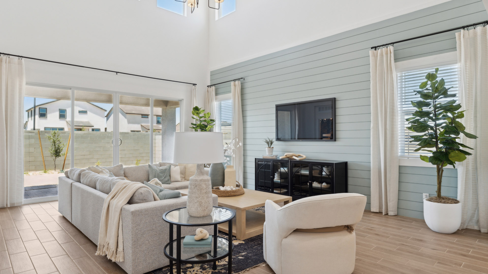 A cozy living room featuring a comfortable couch, a stylish coffee table, and an elegant painting on the wall.