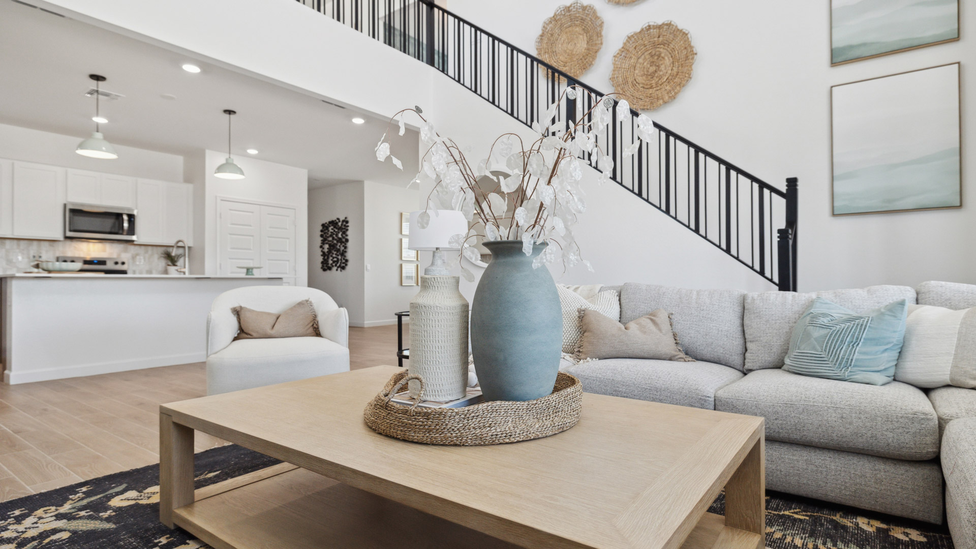 A cozy living room featuring a comfortable couch, a stylish coffee table, and an elegant painting on the wall.