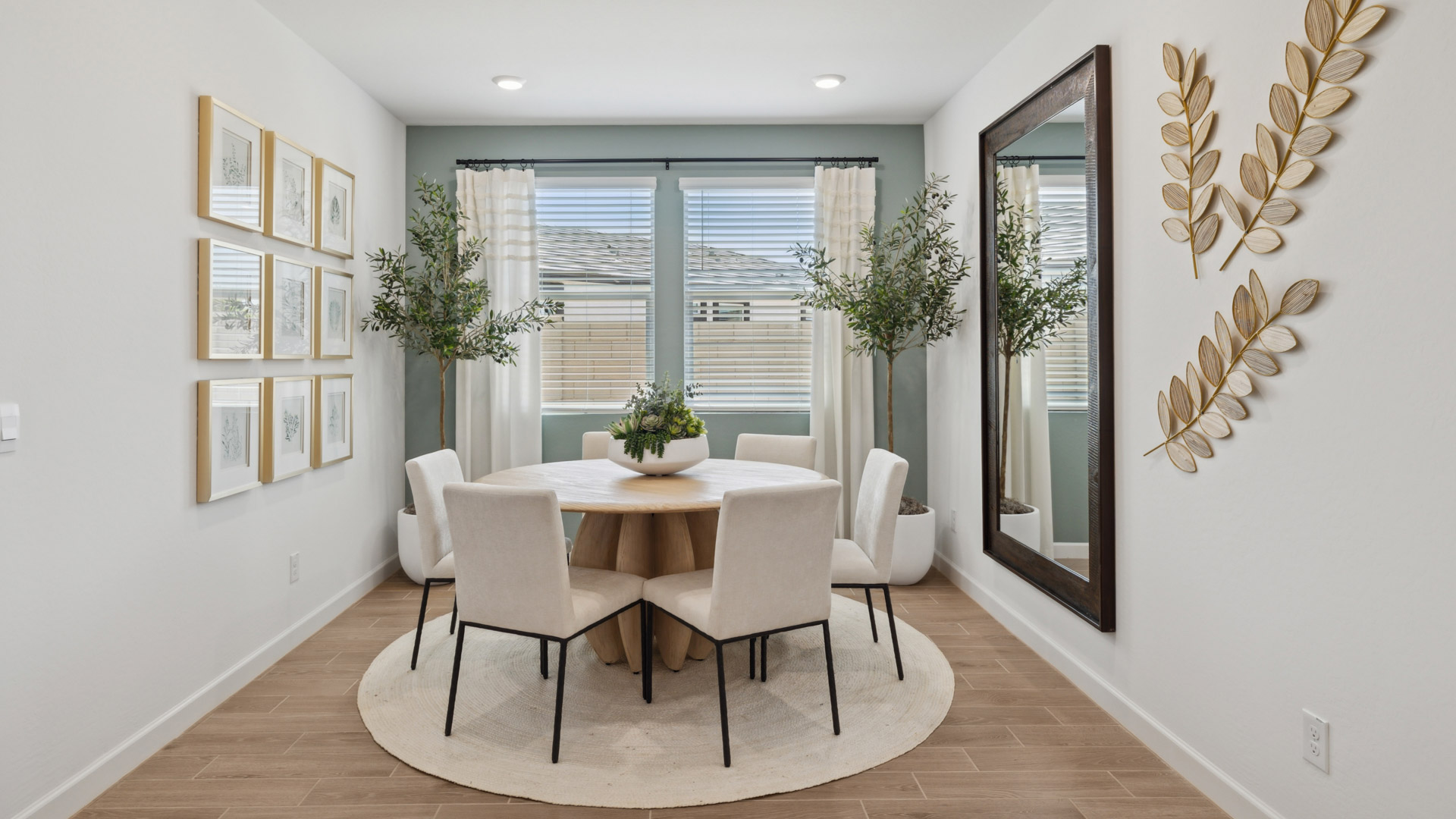 Formal dining room with large windows, vinyl wood floors, and view of the living room