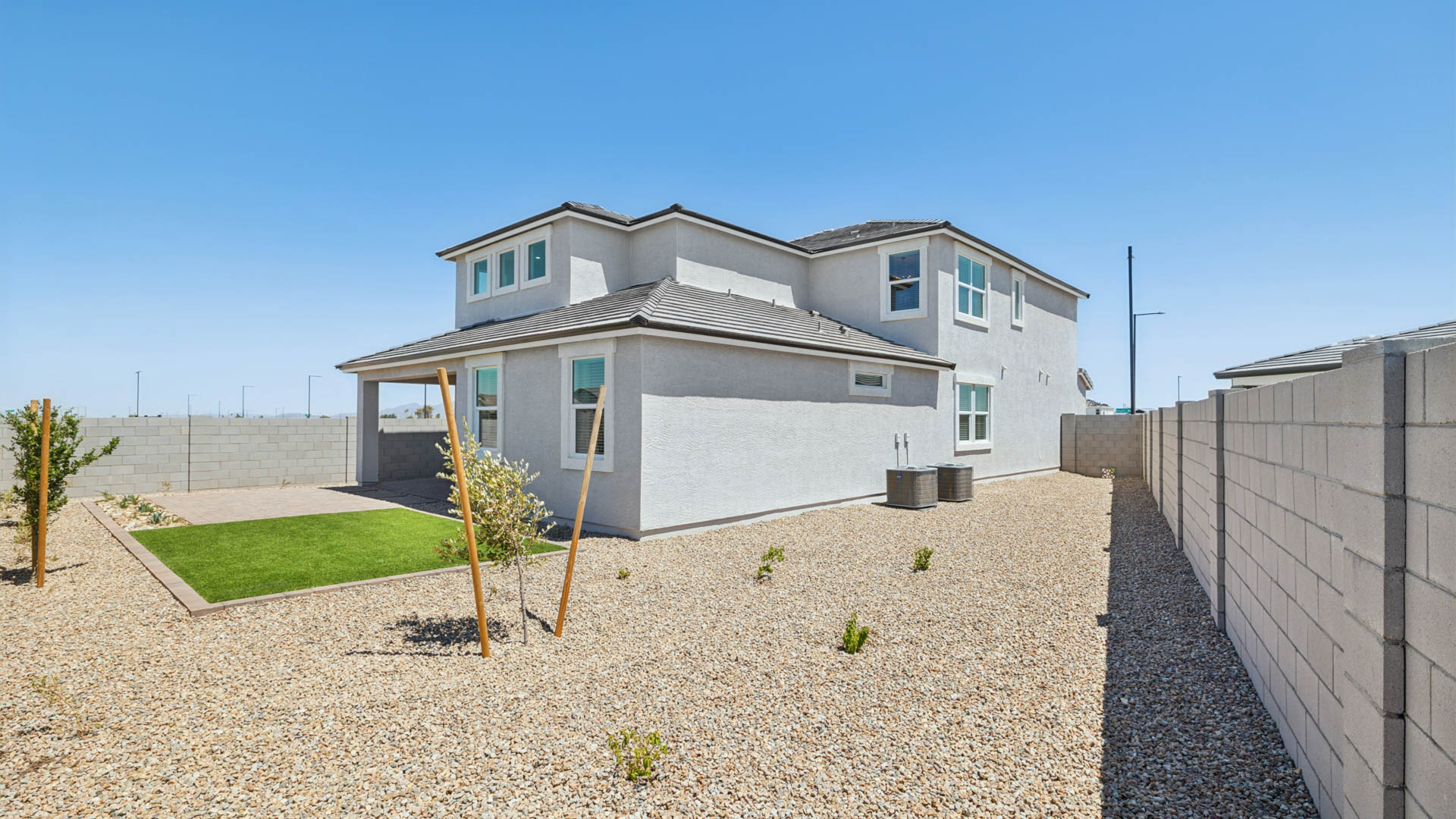 Large fenced-in backyard with a covered patio, perfect for outdoor entertaining.