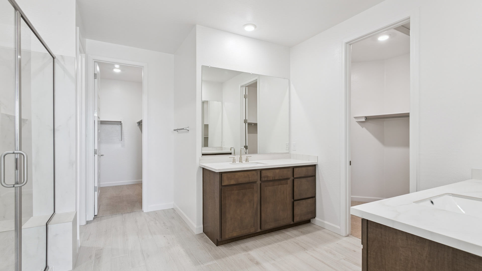 primary bathroom with dual vanities
