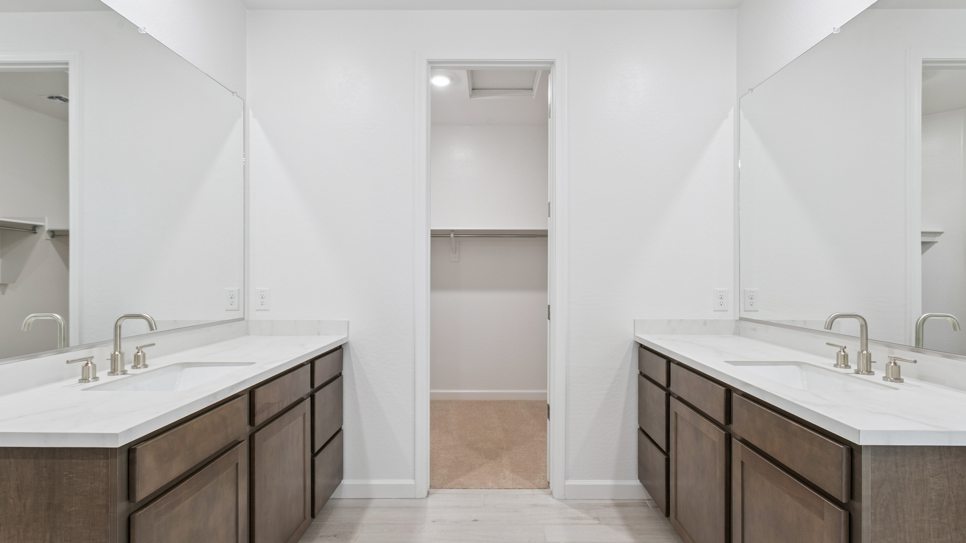 primary bathroom with dual vanities