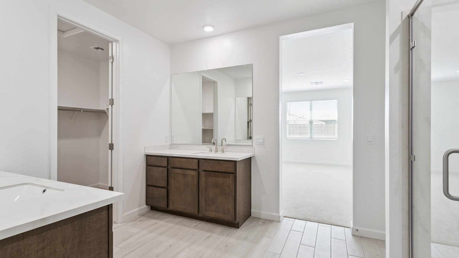 primary bathroom with dual vanities