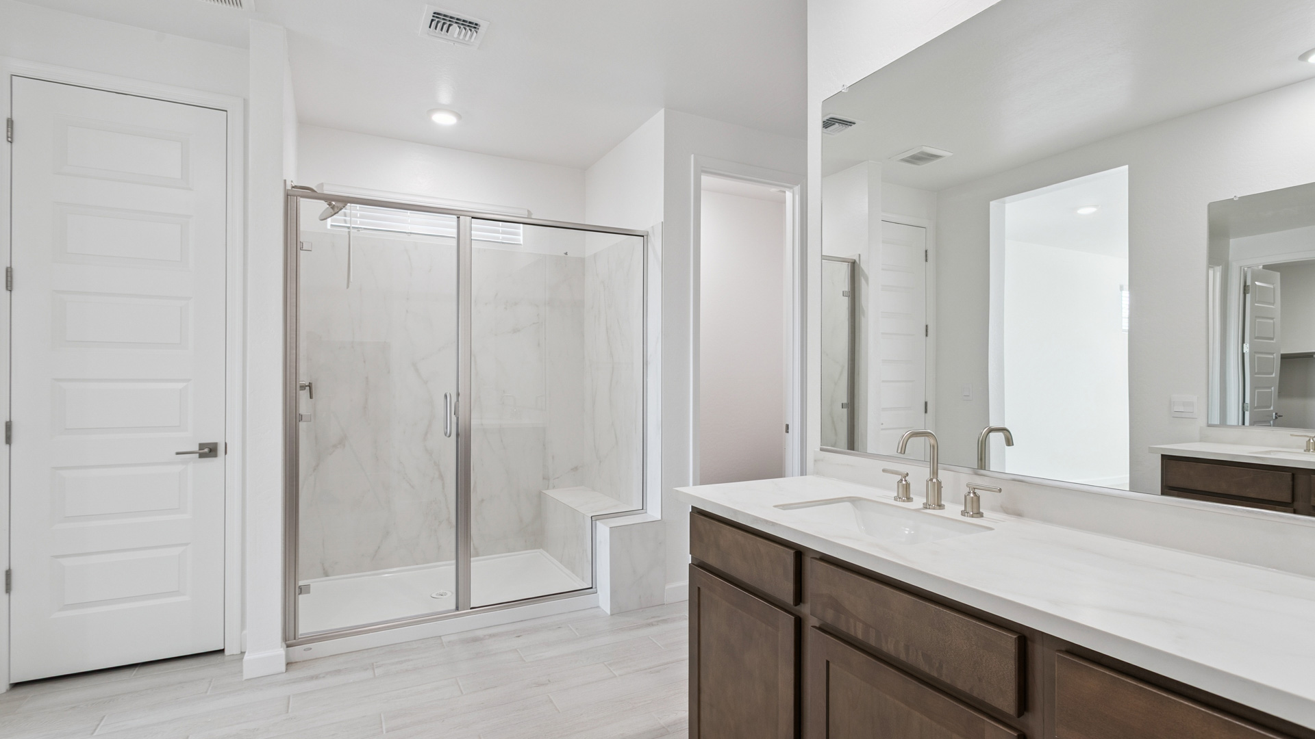 primary bathroom with dual vanities
