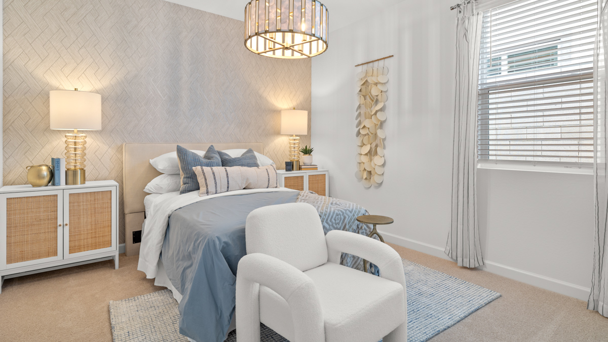 Comfortable guest bedroom featuring neutral-toned walls and a large closet.