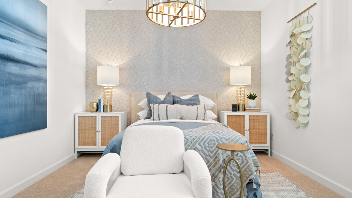 Comfortable guest bedroom featuring neutral-toned walls and a large closet.