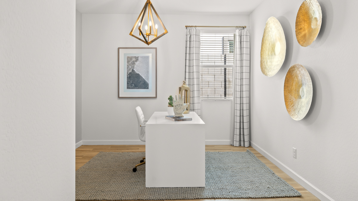 A tidy office featuring a desk, chair, and a window, creating a bright and organized workspace.