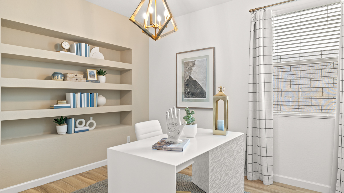 A tidy office featuring a desk, chair, and a window, creating a bright and organized workspace.