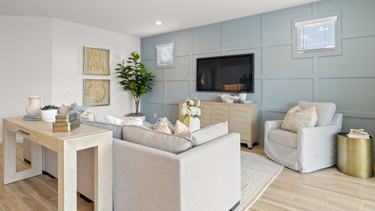 A cozy living room featuring a comfortable couch, a stylish coffee table, and an elegant painting on the wall.
