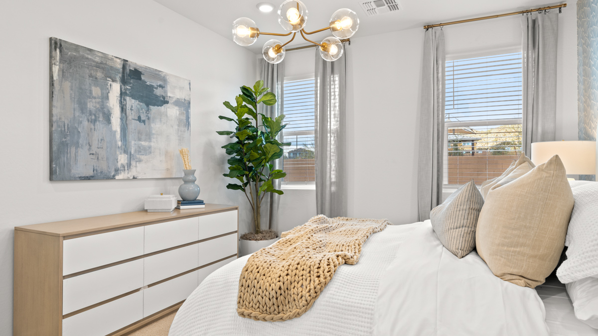 A spacious primary bedroom emphasizing open space and natural lighting.