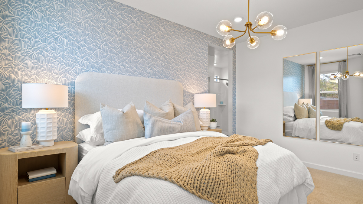 A spacious primary bedroom emphasizing open space and natural lighting.