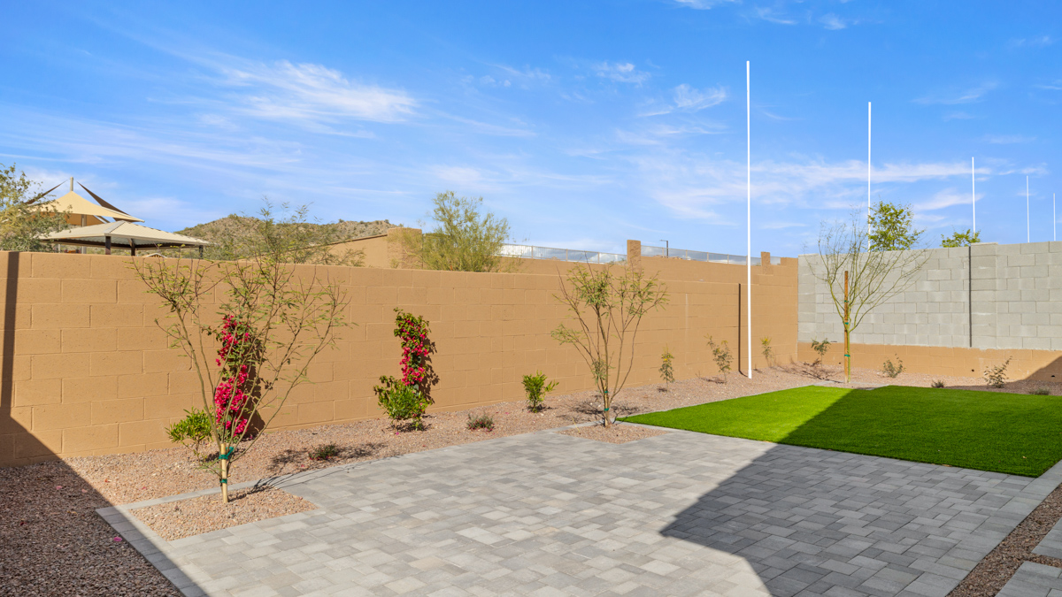 Large fenced-in backyard with a covered patio, perfect for outdoor entertaining.