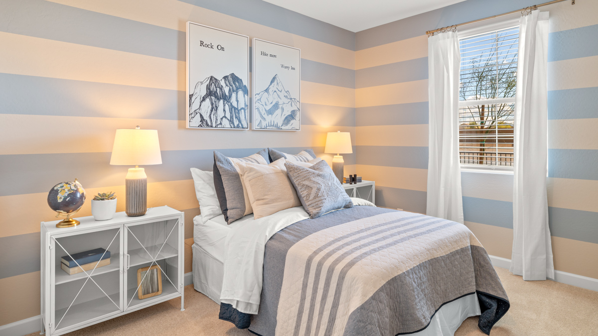 Comfortable guest bedroom featuring neutral-toned walls and a large closet.