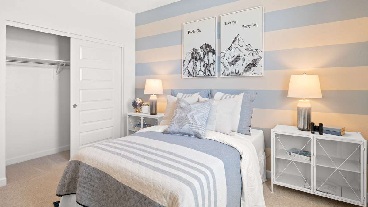 Comfortable guest bedroom featuring neutral-toned walls and a large closet.