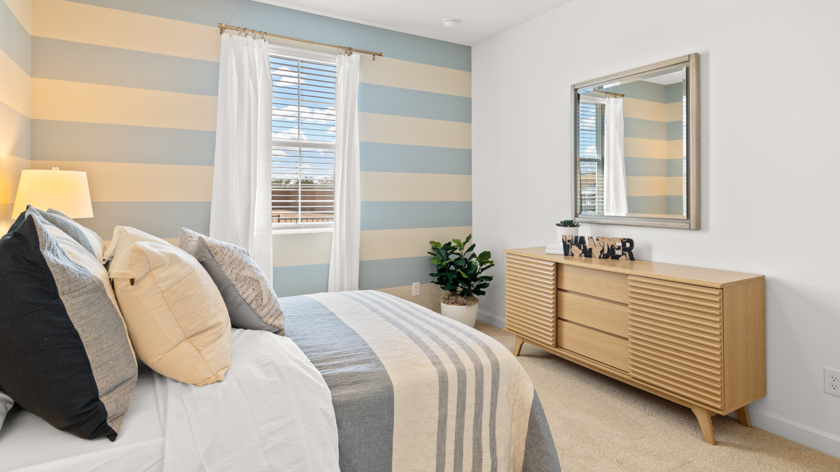 Comfortable guest bedroom featuring neutral-toned walls and a large closet.