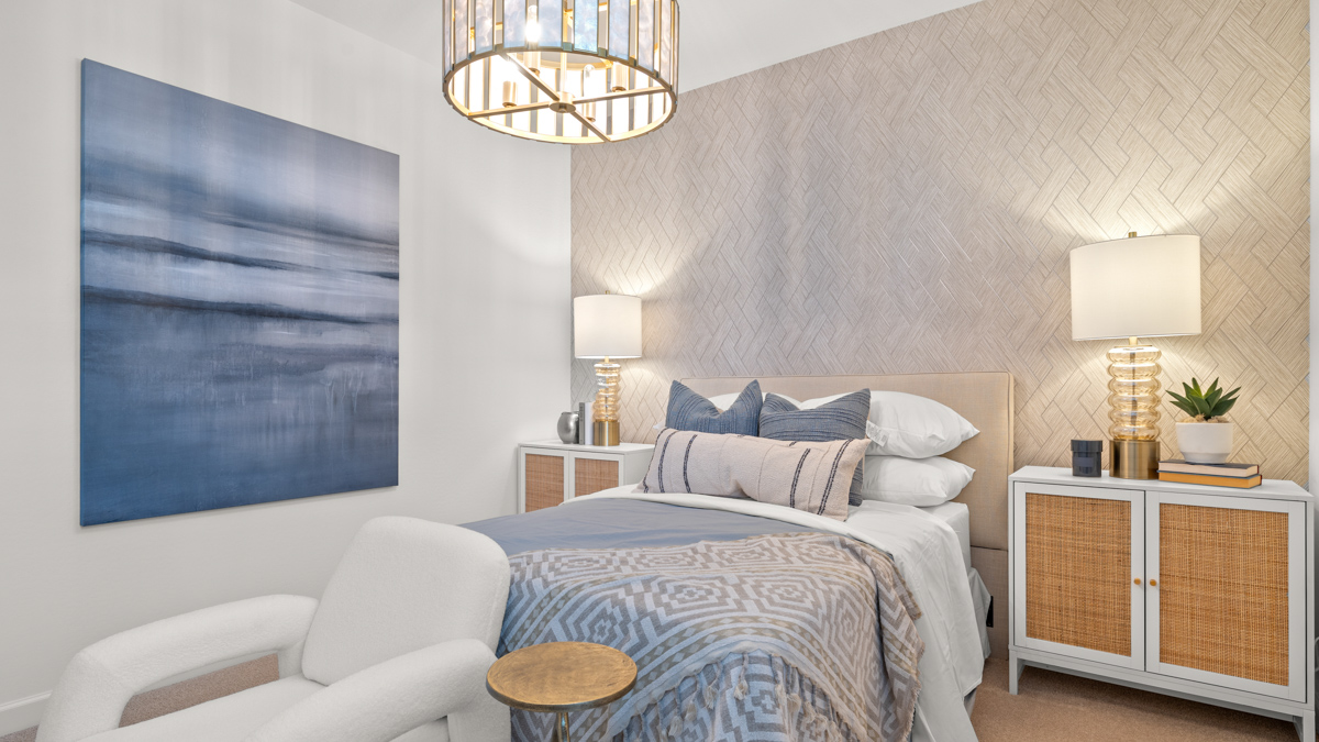 Comfortable guest bedroom featuring neutral-toned walls and a large closet.