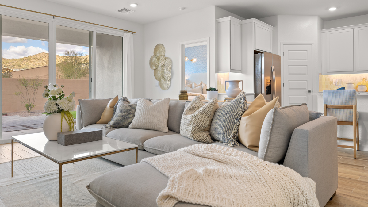 A cozy living room featuring a comfortable couch, a stylish coffee table, and an elegant painting on the wall.