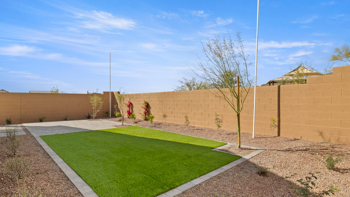 Large fenced-in backyard with a covered patio, perfect for outdoor entertaining.