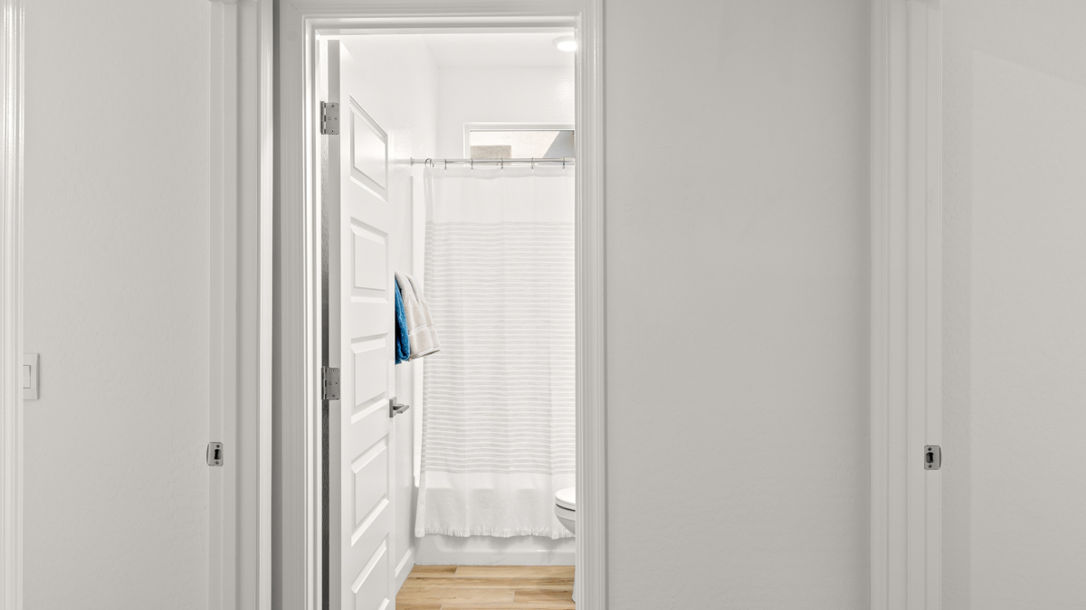 Hallway leading to a second bathroom.