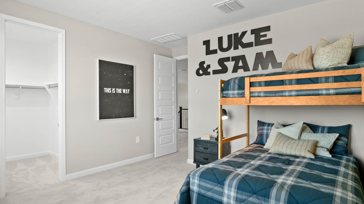 A vibrant kids' bedroom showcasing a neatly made bunkbed, a stylish dresser, and a playful painting that adds charm.