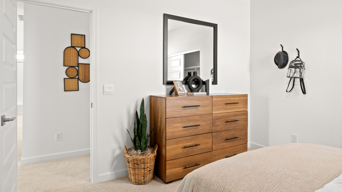 Comfortable guest bedroom featuring neutral-toned walls and a large closet.