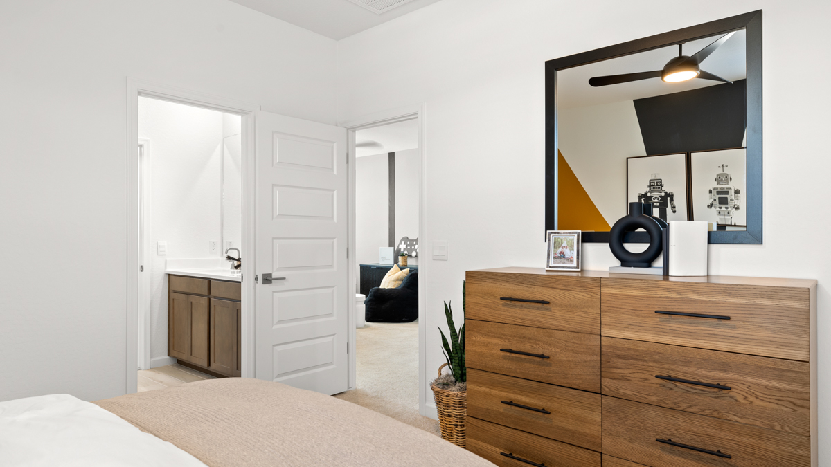 Comfortable guest bedroom featuring neutral-toned walls and a large closet.
