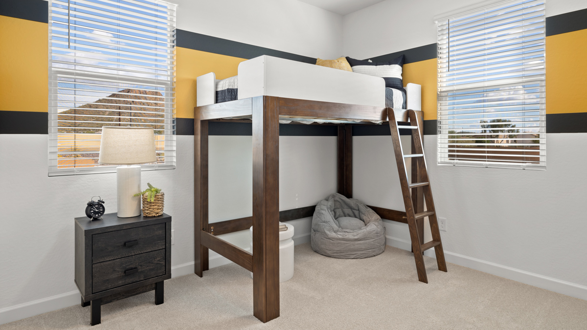 Comfortable guest bedroom featuring neutral-toned walls and a large closet.