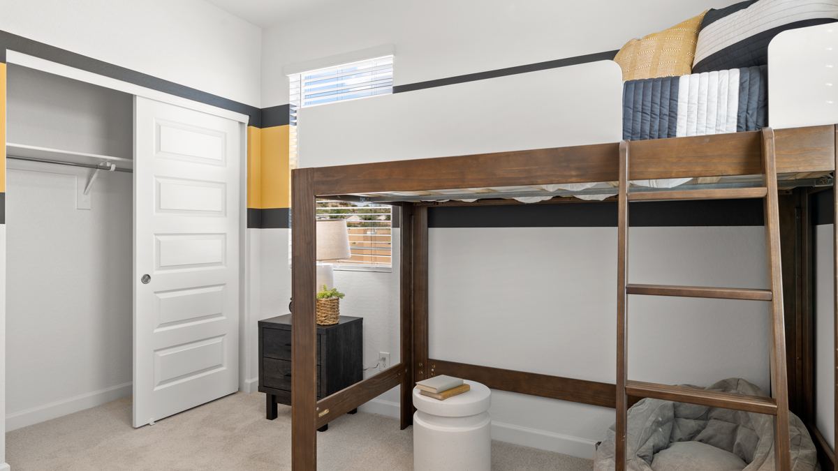 Comfortable guest bedroom featuring neutral-toned walls and a large closet.