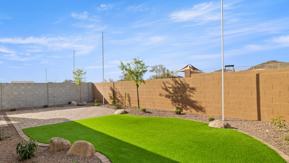 Large fenced-in backyard with a covered patio, perfect for outdoor entertaining.