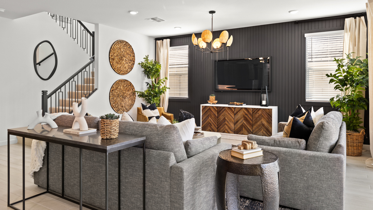 A well-organized living room that includes a kitchen and dining area, creating a warm and welcoming environment for gatherings.
