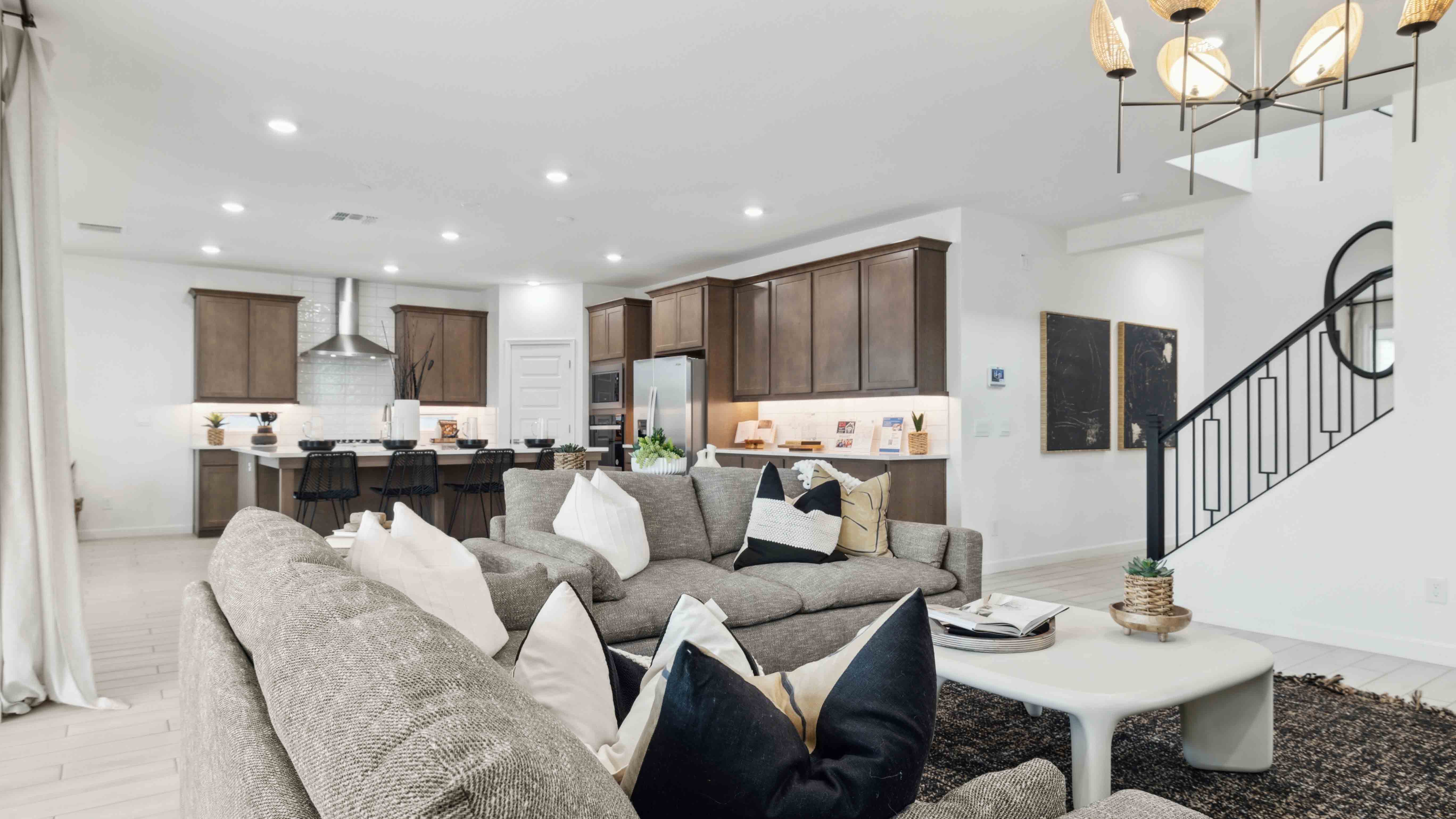 A well-organized living room that includes a kitchen and dining area, creating a warm and welcoming environment for gatherings.