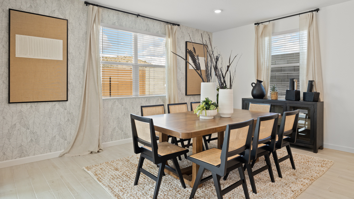 Formal dining room with large windows, vinyl wood floors, and view of the backyard.