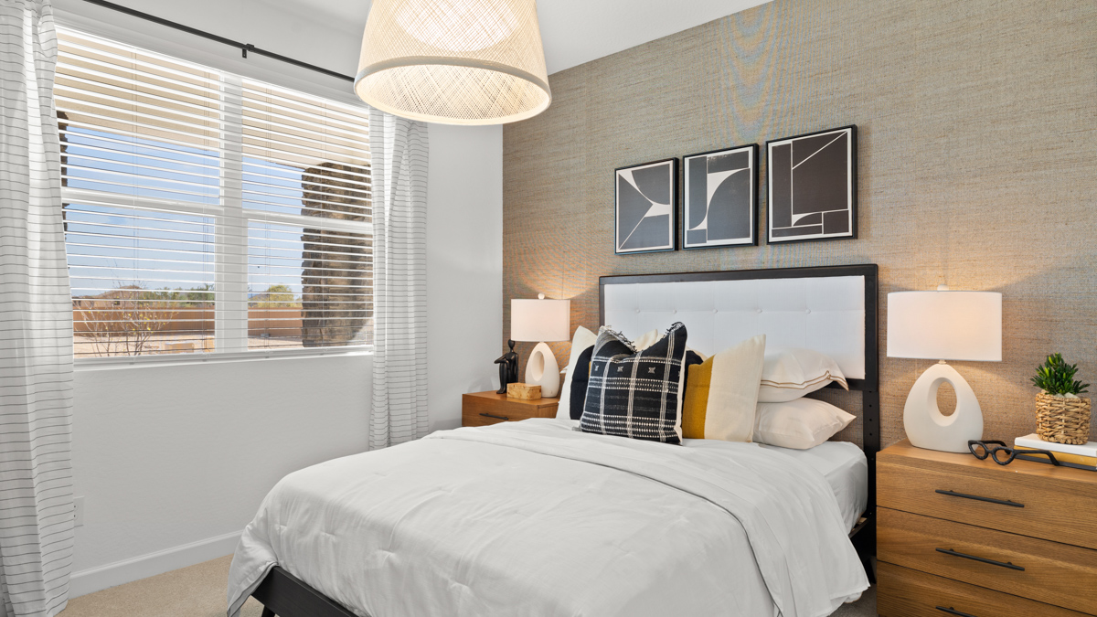 Comfortable guest bedroom featuring neutral-toned walls and a large closet.