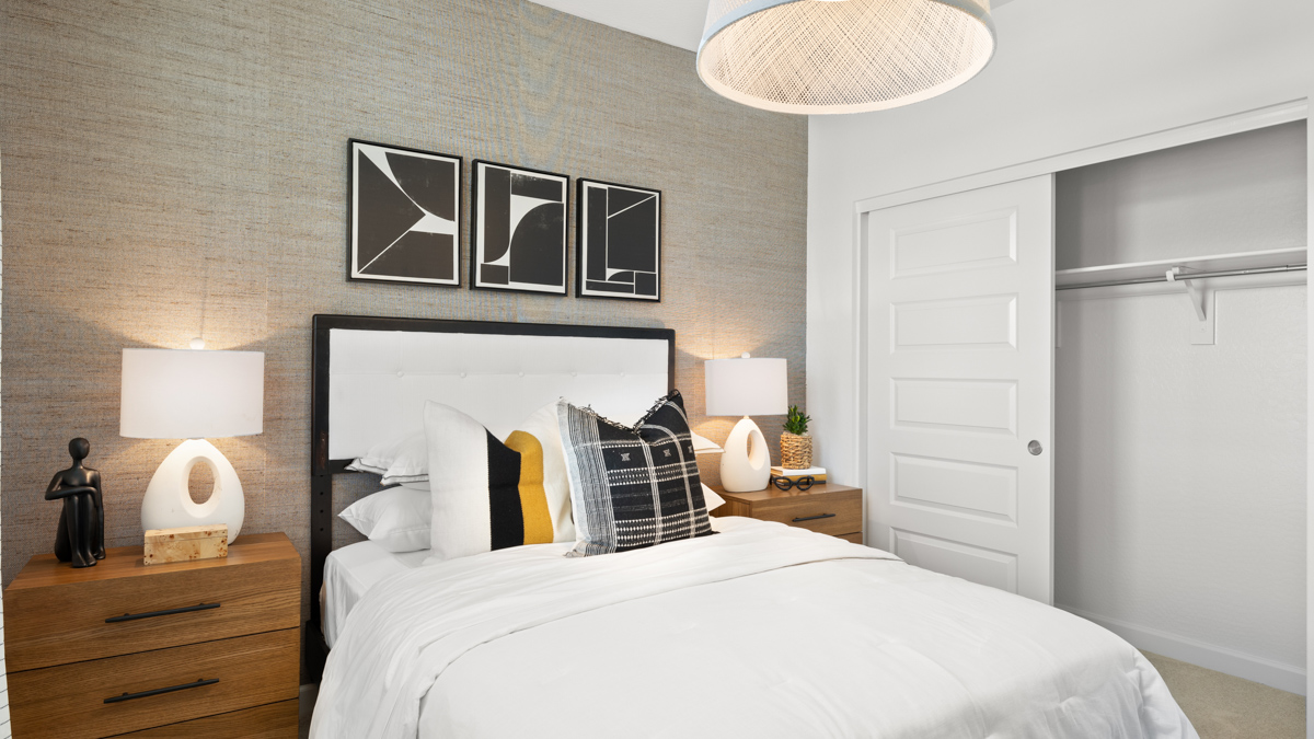 Comfortable guest bedroom featuring neutral-toned walls and a large closet.