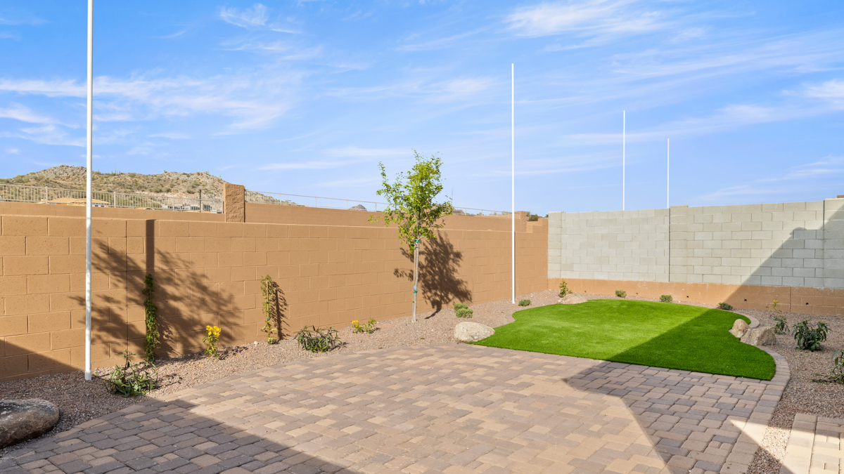 Large fenced-in backyard with a covered patio, perfect for outdoor entertaining.
