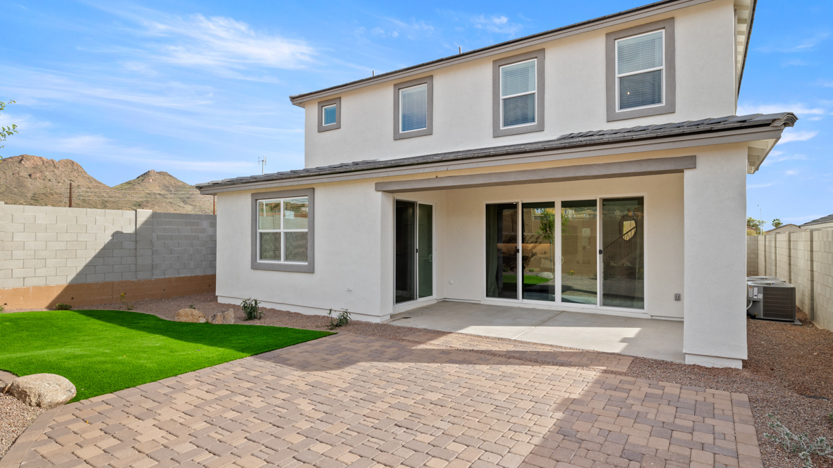 Large fenced-in backyard with a covered patio, perfect for outdoor entertaining.
