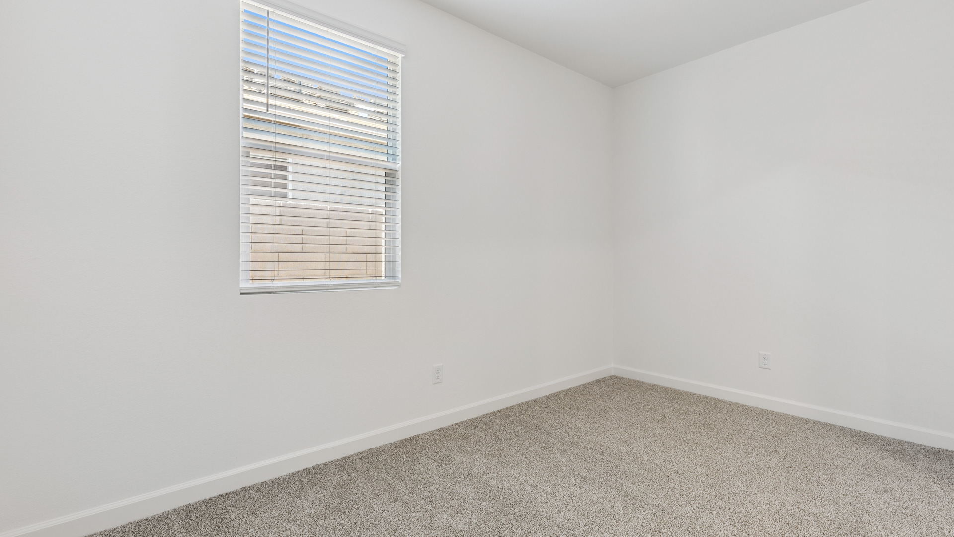 Comfortable guest bedroom featuring neutral-toned walls and a large closet.