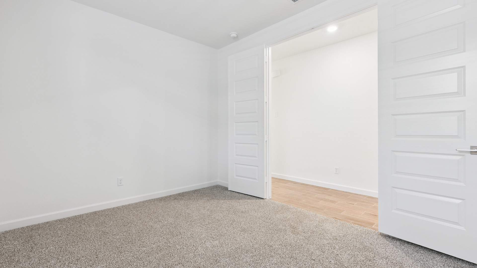 Comfortable guest bedroom featuring neutral-toned walls and a large closet.