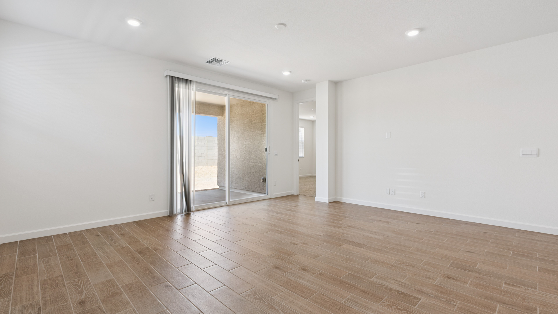 A well-organized living room that includes a kitchen and dining area, creating a warm and welcoming environment for gatherings.