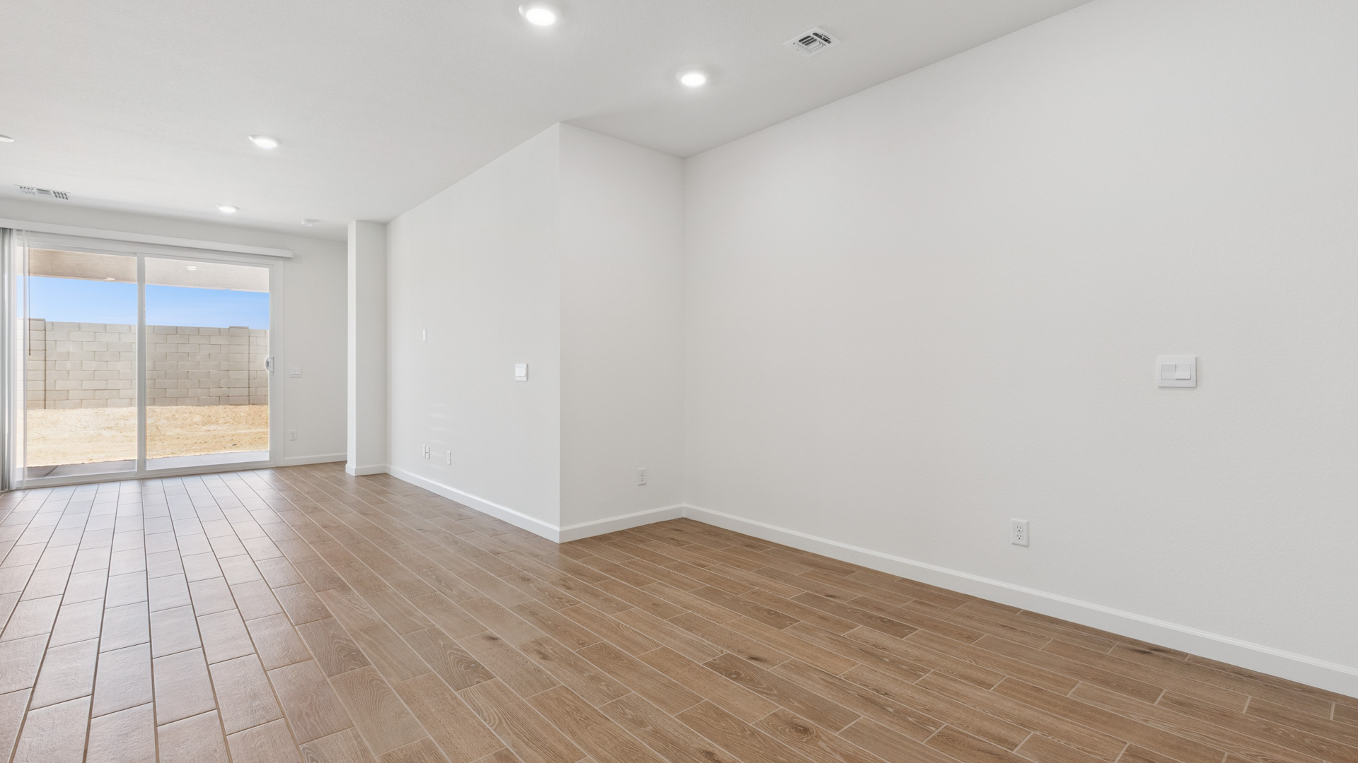 A well-organized living room that includes a kitchen and dining area, creating a warm and welcoming environment for gatherings.