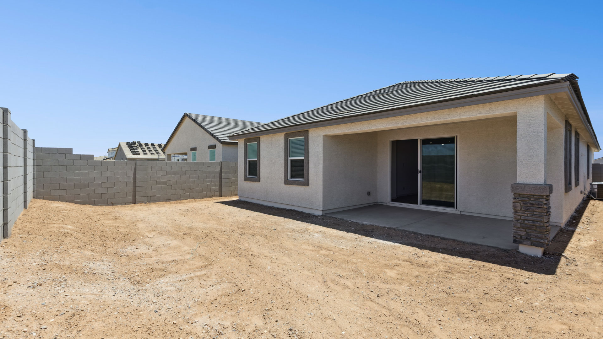 Large fenced-in backyard with a covered patio, perfect for outdoor entertainment.
